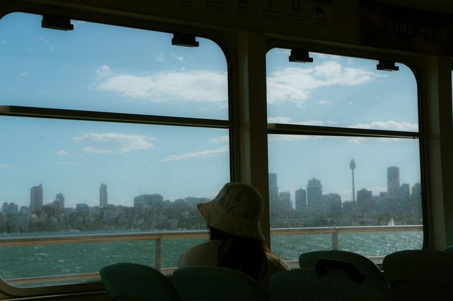 Young female student on Australian university campus with city skyline