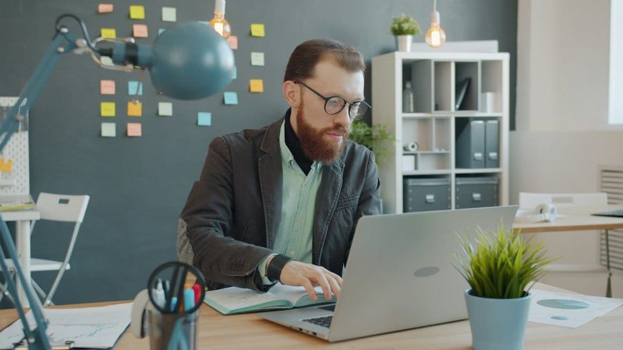 Man working on laptop in modern creative office